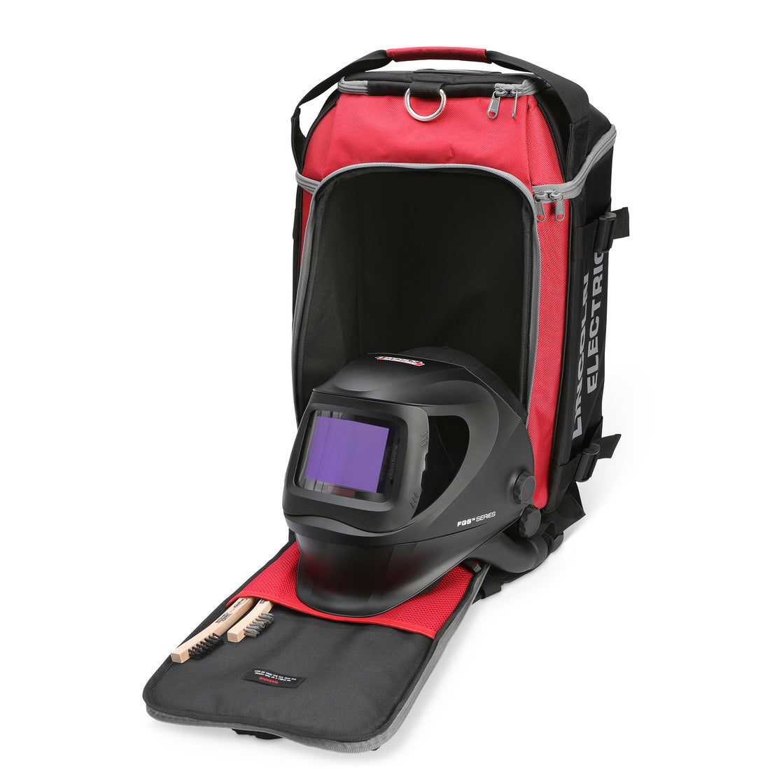 Red and black welding backpack with a helmet and tools on a white background